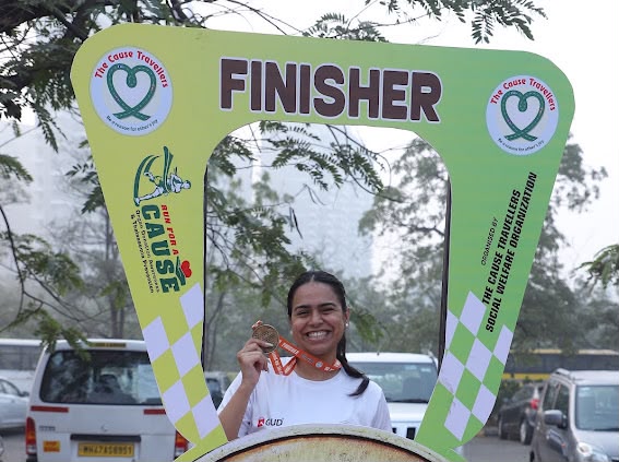Finisher celebrating with her medal